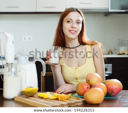 cheerful woman  drinking milk shake with mango