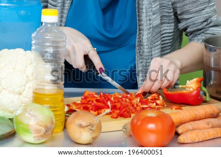 Closeup of slicing  pepper on cook-table