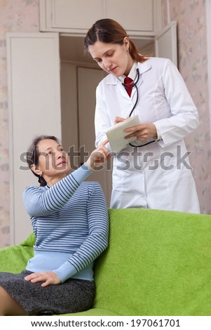 doctor talks with sick mature patient at hospital