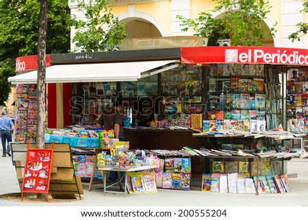 GIRONA, SPAIN - JUNE 12, 2014:  News stands in Girona, Spain. Outdoor stands with newspapers and magazines at city street.