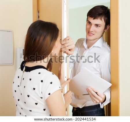 guy conducting  survey among people at door