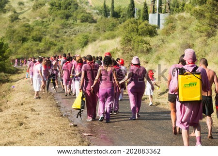 HARO, SPAIN - JUNE 29, 2014: People walking to town after Haro Wine Festival. People pour wine at each other from buckets during festival Batalia de Vino