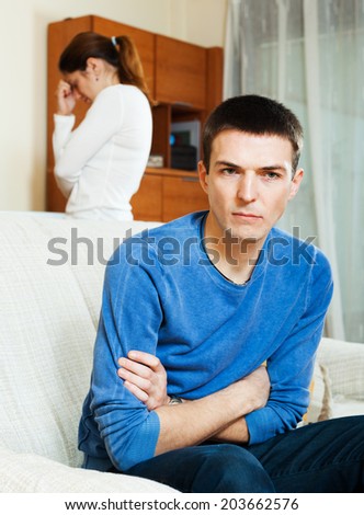 Family quarrel. Depressed man listening to woman at home