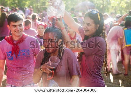 HARO, SPAIN - JUNE 29, 2014:  Haro Wine Festival. People pour wine at each other from buckets during festival Batalia de Vino