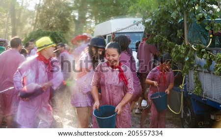 HARO, SPAIN - JUNE 29, 2014: People at Haro Wine Festival festival. People pour wine at each other from Botas and buckets during festival Batalia de Vino