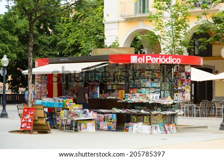 GIRONA, SPAIN - JUNE 12, 2014:  News stands in Girona, Spain. Outdoor stands with newspapers