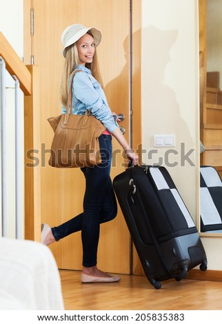 Woman with handbag and trunk going on leave