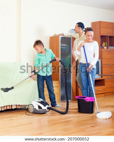 Ordinary family doing  cleaning with  cleaning equipment in living room