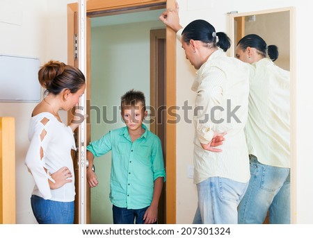Parents meeting with scold of teenage son in door at home