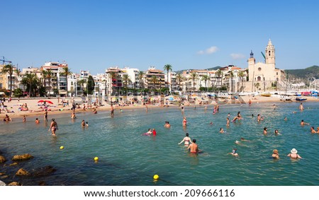 SITGES, SPAIN - AUGUST 6: Mediterranean beach in summer sunny day in August 6, 2013 in Sitges, Spain.  Town is known for its sandy  coast