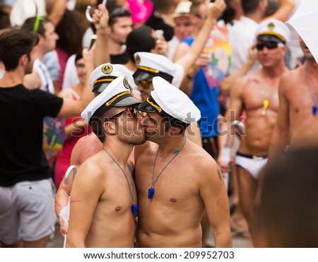 stock-photo-sitges-spain-june-kissing-men-at-procession-in-last-day-of-gay-pride-parade-in-sitges-209952703.jpg