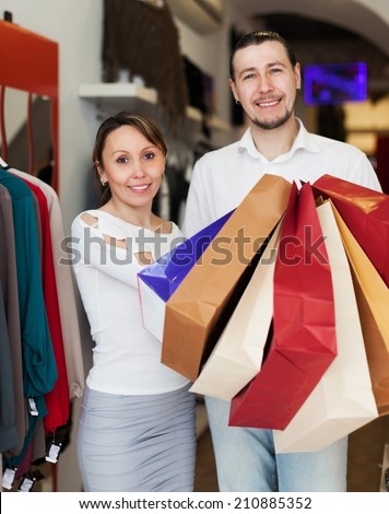 Man and woman with shopping bags at fashion boutique