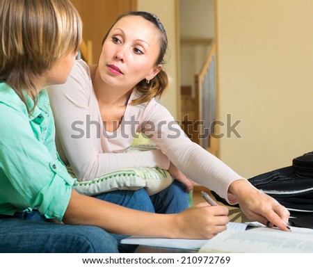 Young mother helping his son with homework