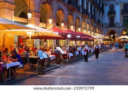 Street restaurants at Placa Reial in summer night. Barcelona, Spain