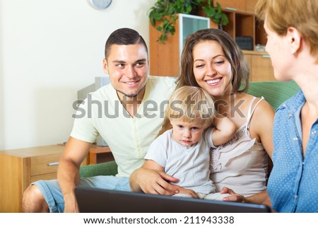 Happy family with child talking with insurance agent
