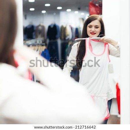 Brunette long-haired woman  at clothing store