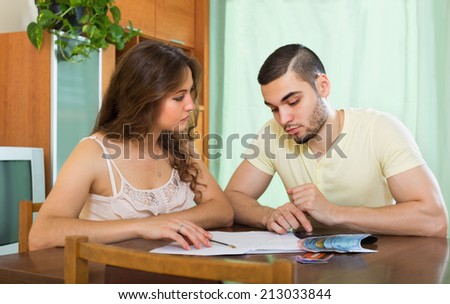 Ã?Â�Ã?Â¡ouple with money and financial documents  in living room