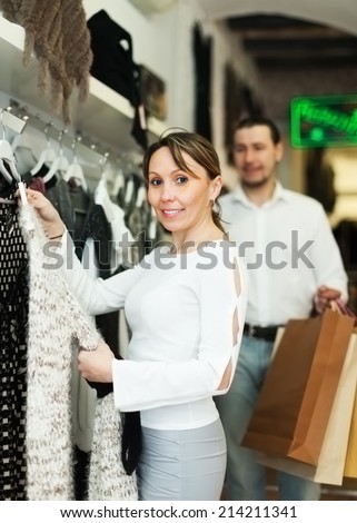 couple choosing clothes at fashion market together