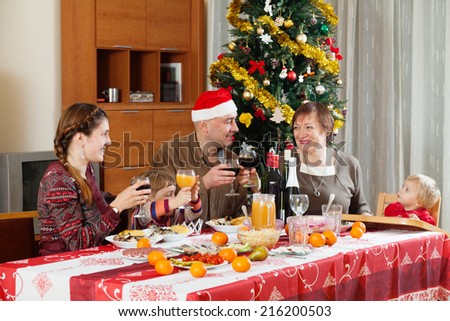family of three generations celebrating New Year over celebratory table at home