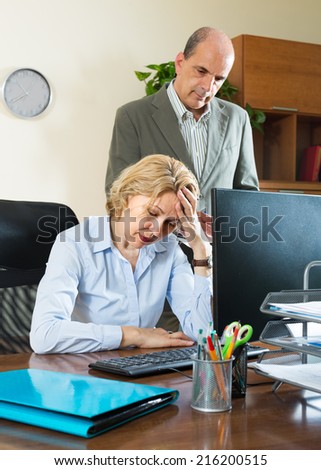 Office scene with angry aged chief and elderly female secretary
