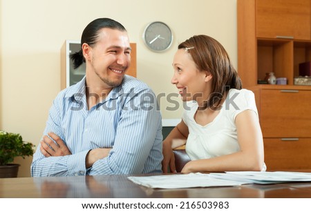 cheerful middle-aged couple in home interior