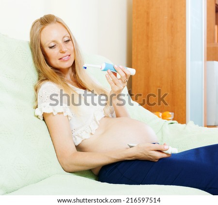 pregnancy woman looking tooth brush at living room