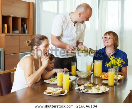 multigeneration family  eating fish with vegetables