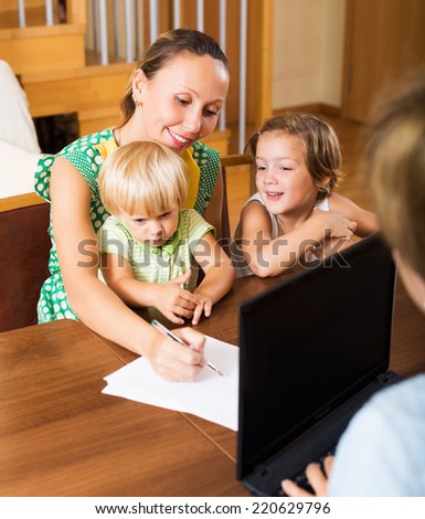 Satisfied mother and banking assistant arranging mortgage details