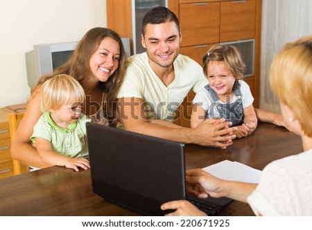 Insurance agent consulting happy young family with kids indoor
