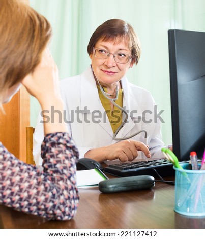 Female patient having medical consultation  at  office of senior doctor