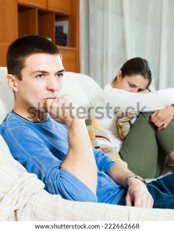 Family quarrel. Unhappy man listening to woman at home