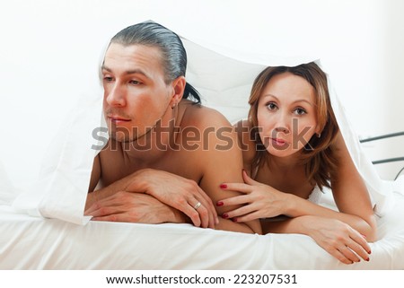 Middle-aged couple having depression in bed
