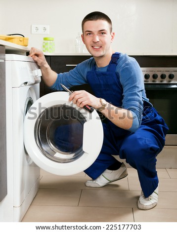 Service worker repairing washing machine