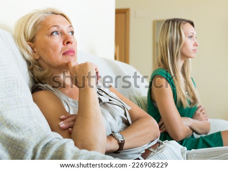 Mature mother and  daughter having quarrel   in home
