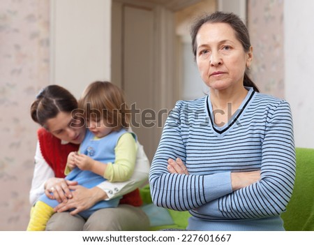Conflict of intergenerational. Sad woman against daughter with baby