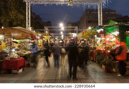 BARCELONA, SPAIN - DECEMBER 2: People  walking at Christmas market near Cathedral in night on December 2, 2013 in Barcelona, Spain