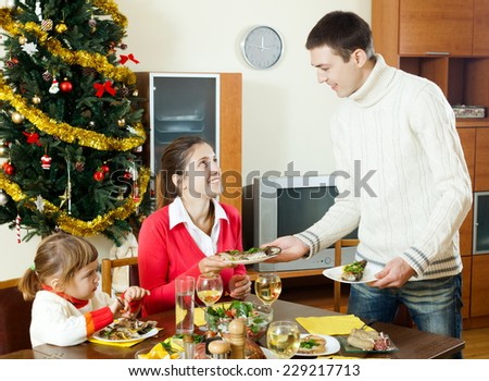 Portrait of Happy family celebrating Christmas  over holiday table at home interior