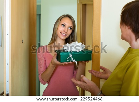Young girl making a present for her elderly mother on Mother\'s Day