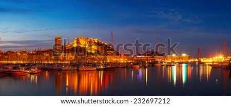 Panorama of port with yachts against Castle of Santa Barbara in night. Alicante, Spain