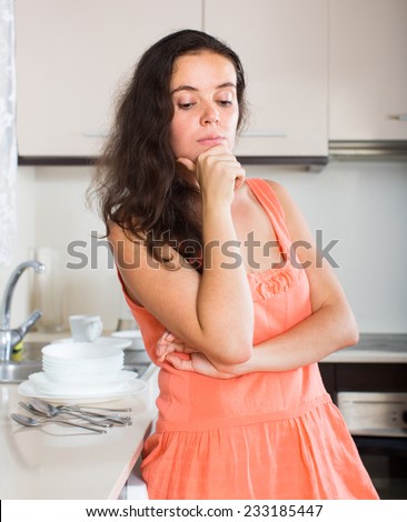 Confused housewife thinking what to prepare for dinner