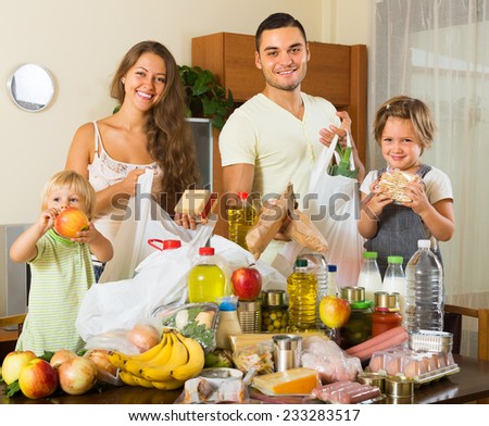 Smiling young family with two children came back from supermarket