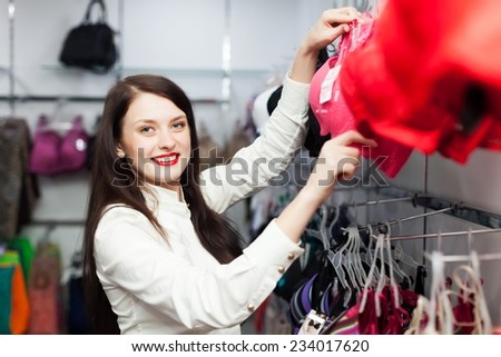 Young woman choosing underwear at clothing store