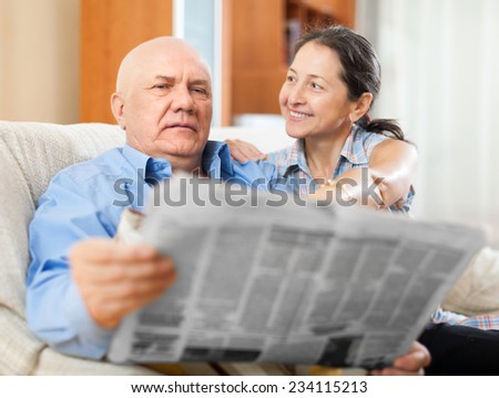 Portrait of a smiling elderly people with newspaper