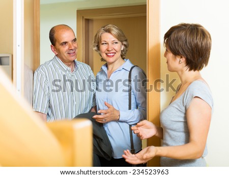 Happy elderly family couple visiting daughter at home
