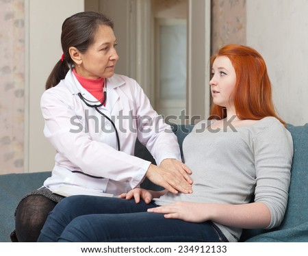 Female teen patient laying down on couch during medical examination