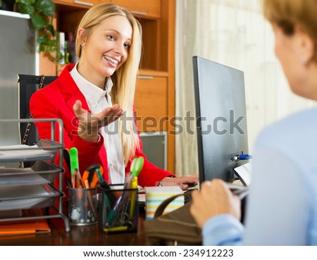 Positive businesswoman checking female candidate for new position in office