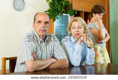 Mature parents with  adult daughter having conflict  in home interior