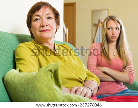 adult daughter and mother having quarrel at home
