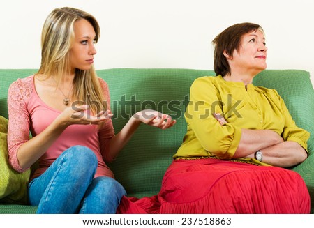 Adult daughter and mature mother having conflict  in home interior