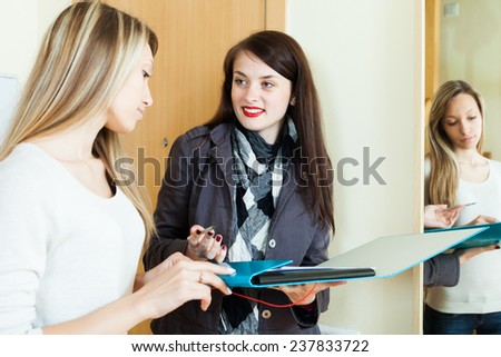 woman answers questions in door at home. Focus on brunette